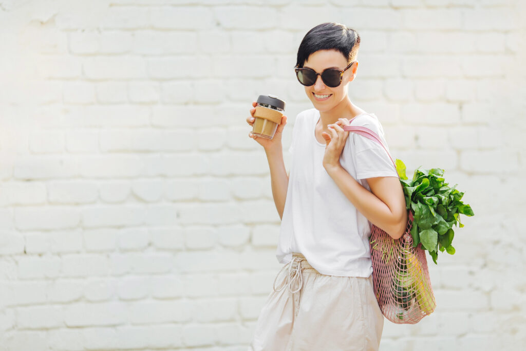 Women walking with her groceries and reusable bag.