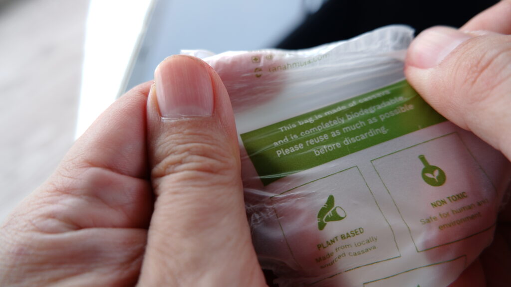 Bag being held by a person at a store that shows it is biodegradable.