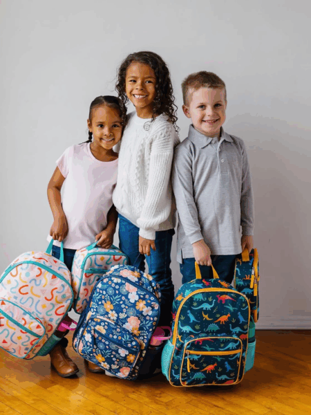 Three children with eco-friendly backpacks for school