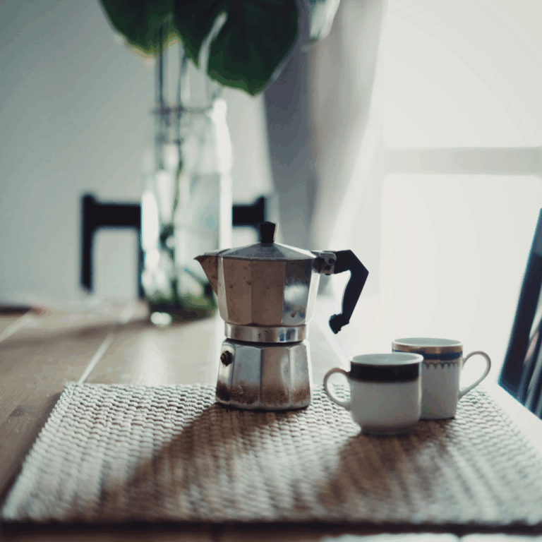 Plastic-free coffee maker on a table with two cups.