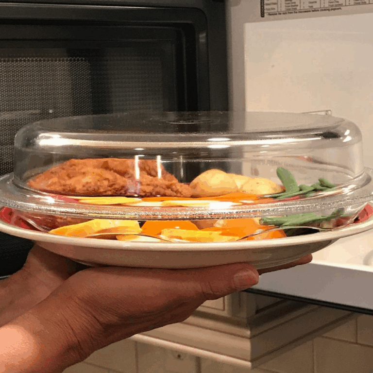 Plastic free microwave cover over a plate of food going into the microwave