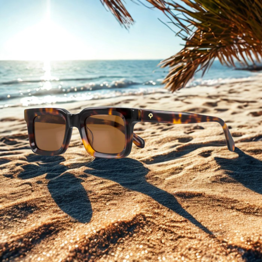 Sunglasses on the sand at the beach.
