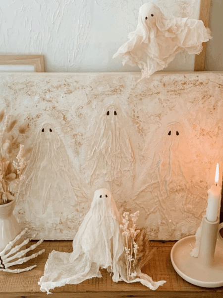 Ghost DIY Halloween decor on a table with a candle