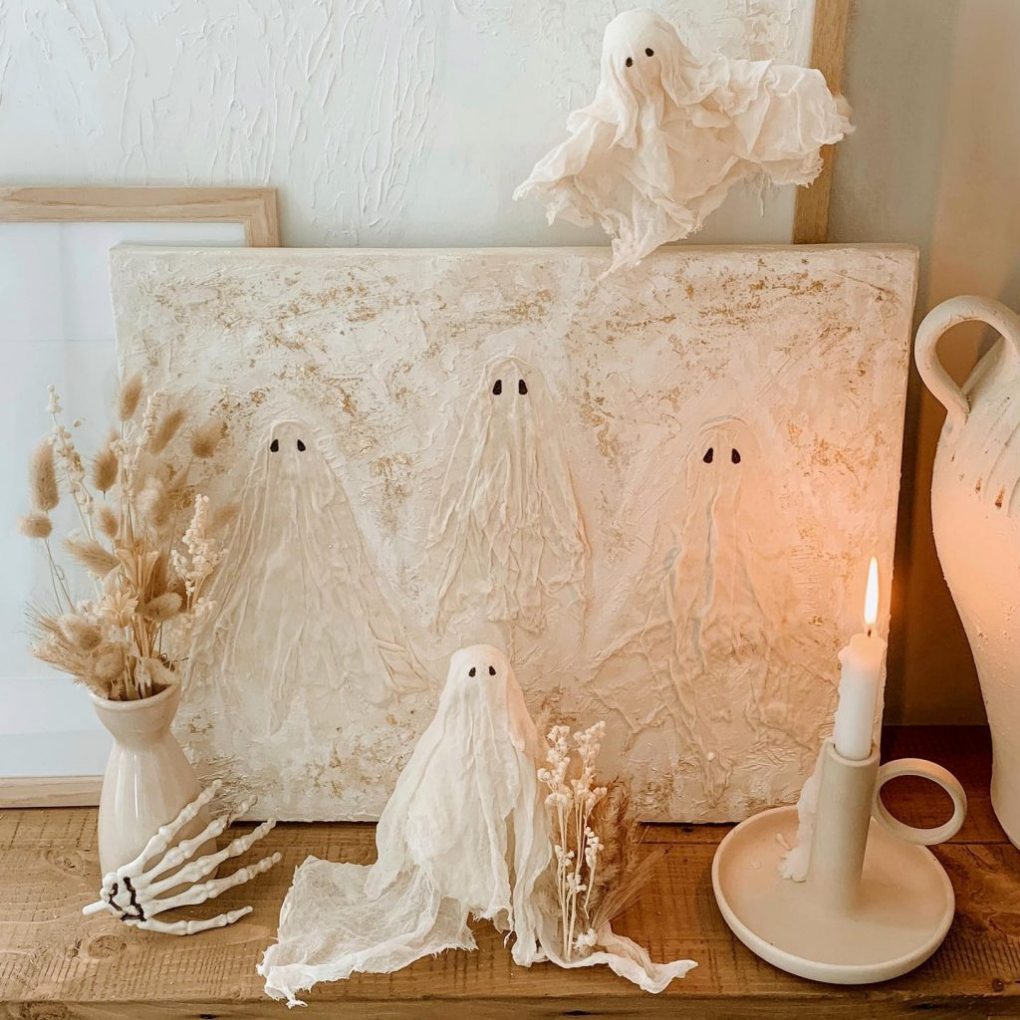 Ghost DIY Halloween decor on a table with a candle