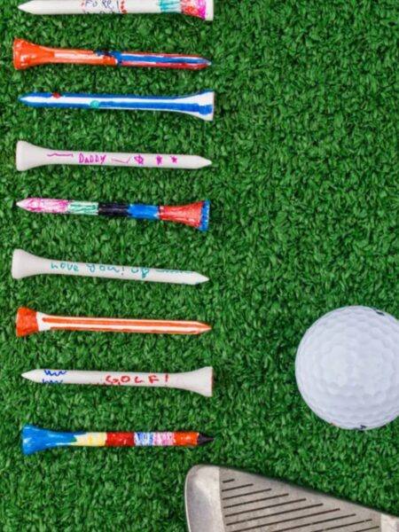 Fathers Day Craft painted golf tees next to a golf ball and club