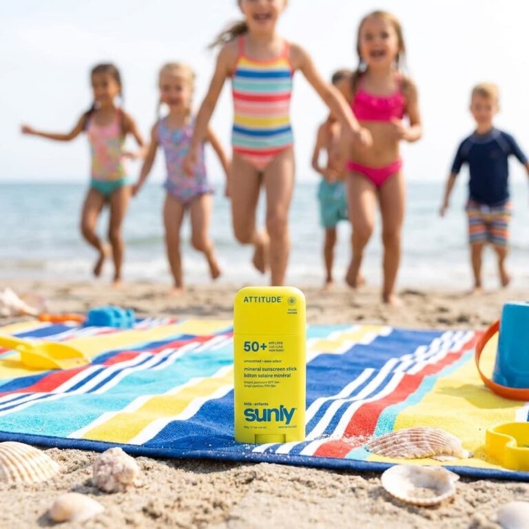 Non Toxic Sunscreen Attitude Kids image of sunblock on a beach blank on the sand and kids in the background running