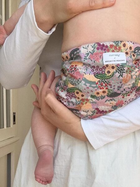 What are the best cloth diapers. Mom holding baby close up of the Esembly Cloth Diaper.