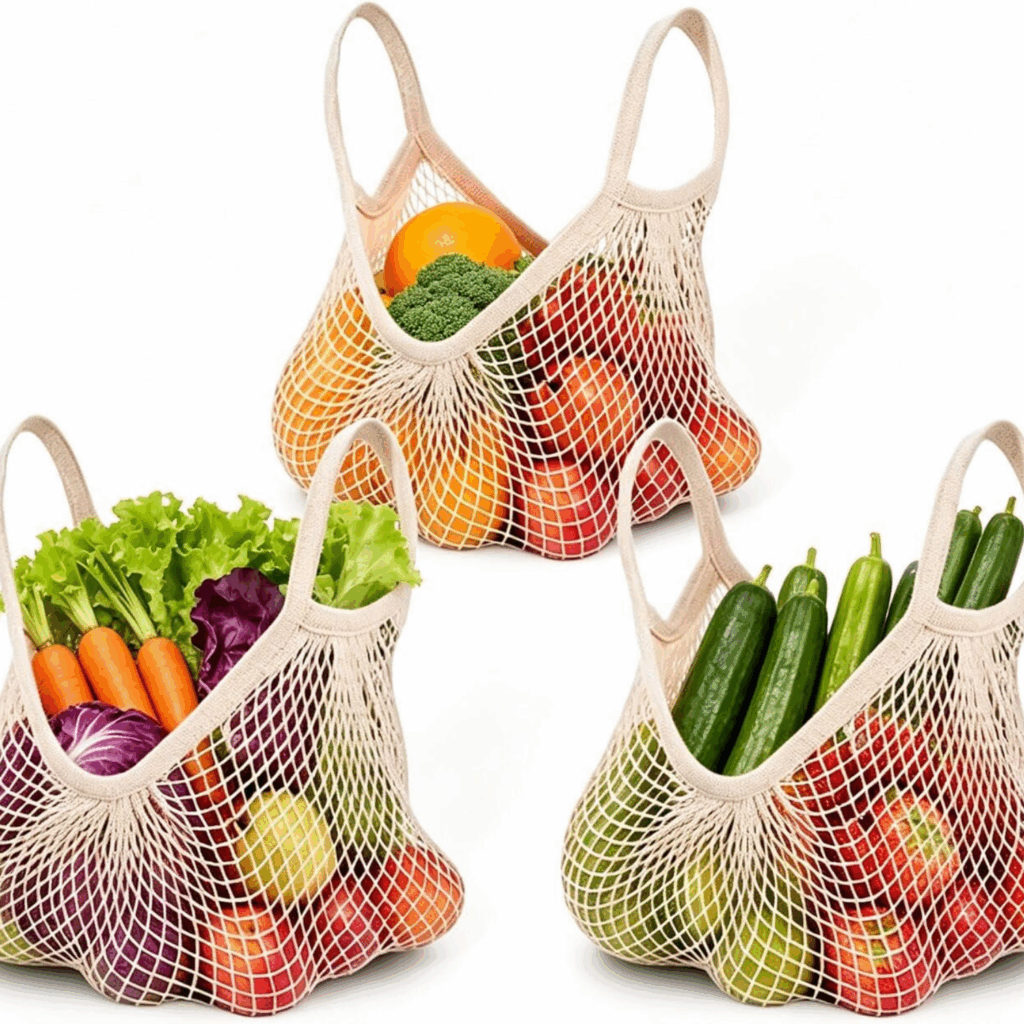 3 mesh grocery produce bags with fruit and vegetables inside.