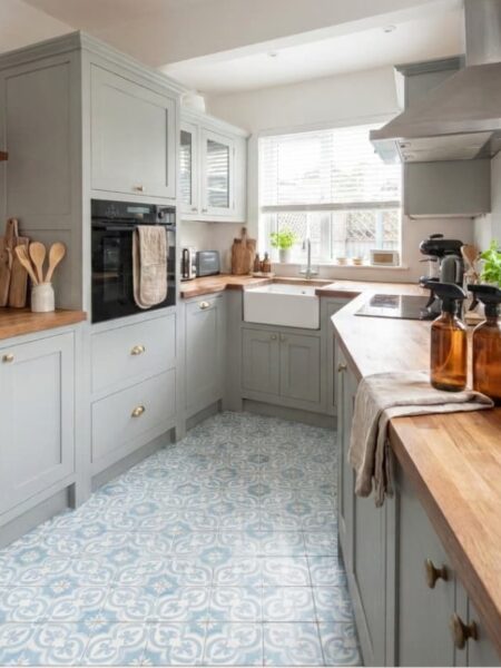 non toxic living ideas non-toxic living ideas kitchen with a window, glass cleaning bottles on the counter, blue and white floor tile, cooking utensils on the counter.