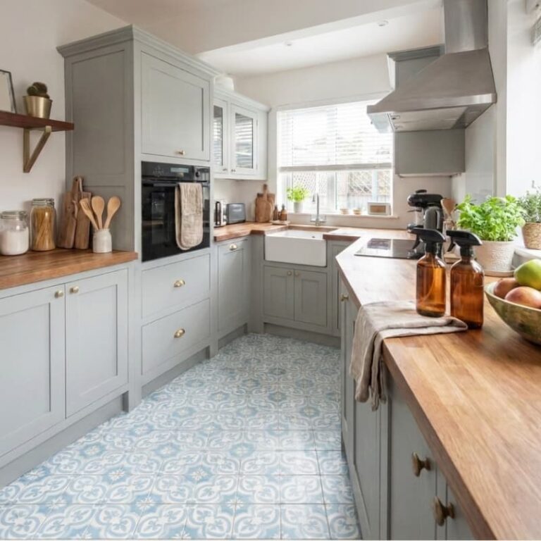 non toxic living ideas non-toxic living ideas kitchen with a window, glass cleaning bottles on the counter, blue and white floor tile, cooking utensils on the counter.