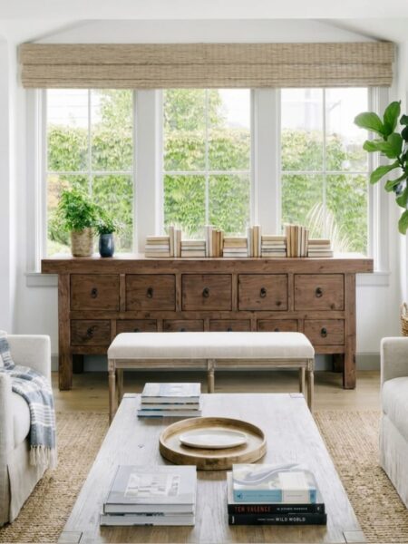 Streak-free paned windows in a bright living room above a reclaimed wood console