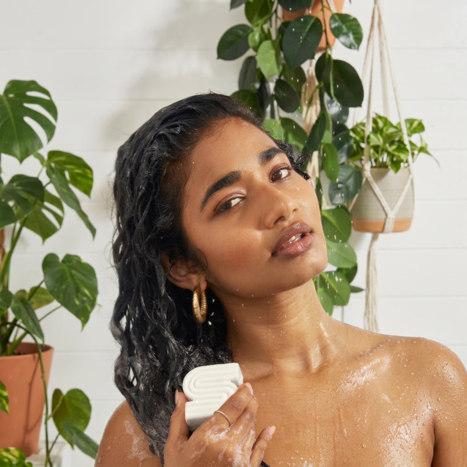 Woman using the Kitsch Ultra Sensitive cleansing bar on her hair