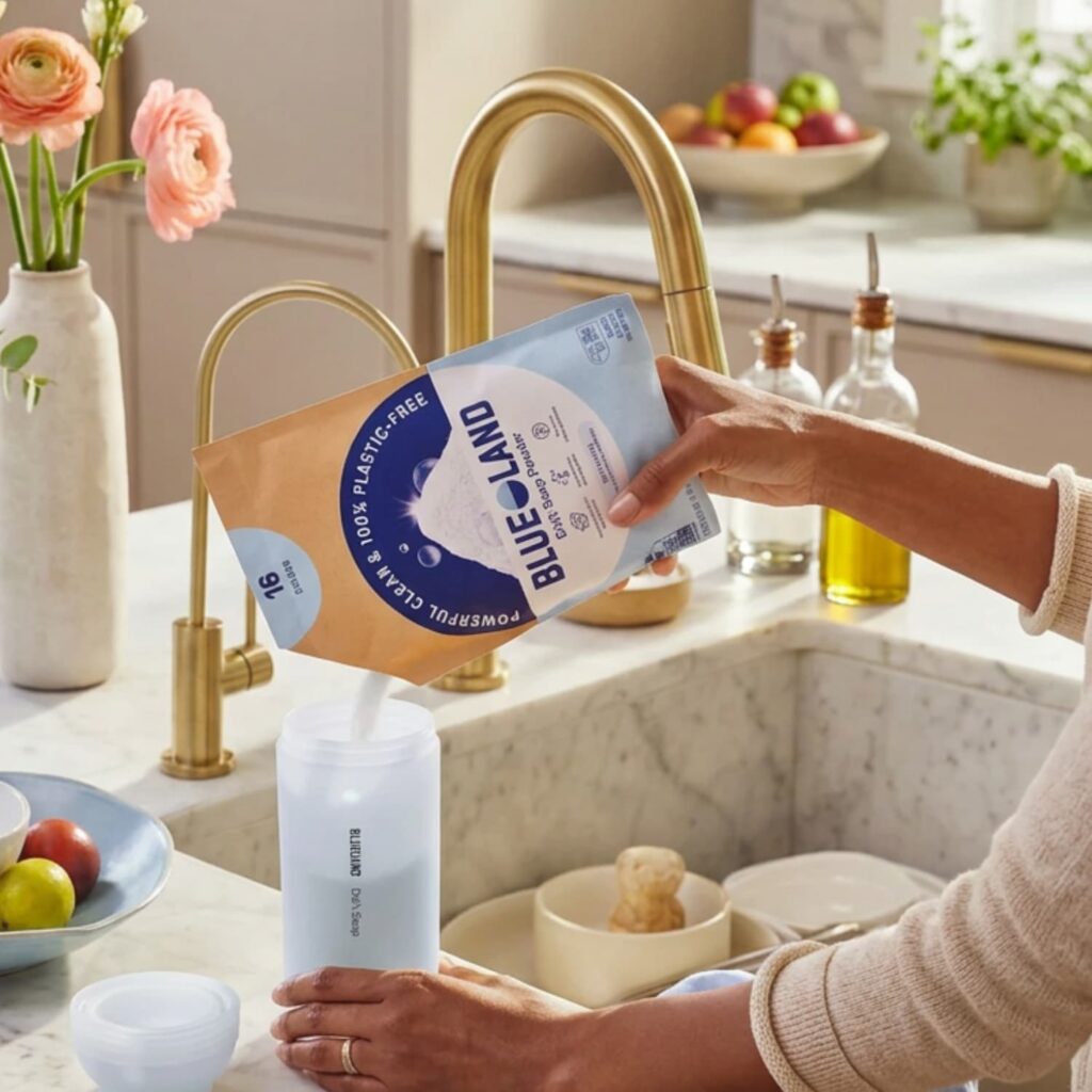 Woman pouring Blueland dishwashing powder into the forever bottle.