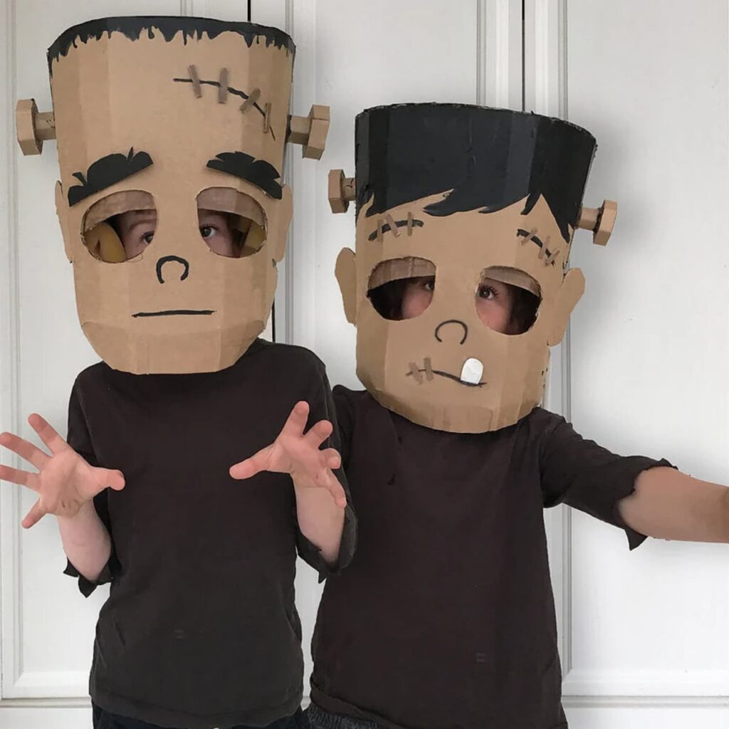 Child wearing a DIY cardboard Frankenstein head costume