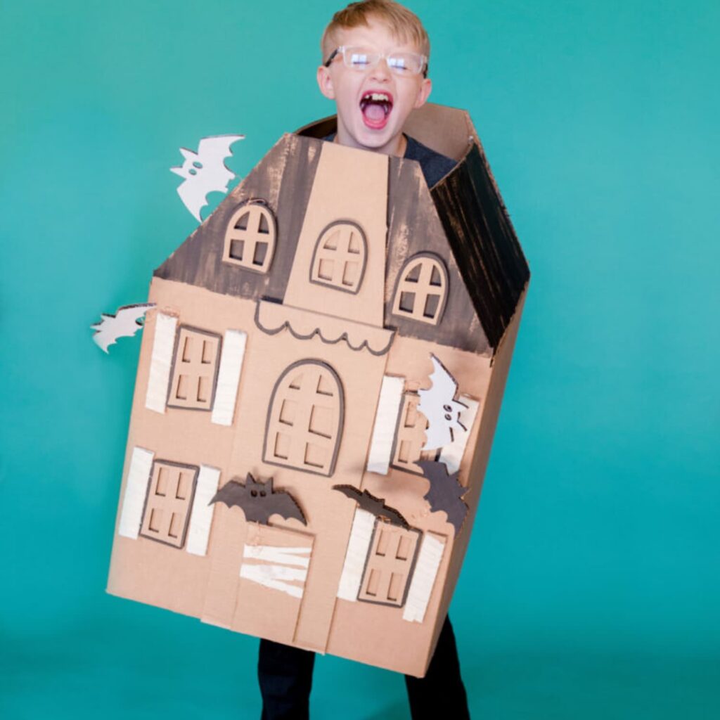 Boy in a DIY haunted gingerbread house costume