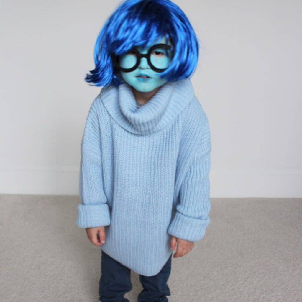 Girl in blue hair and clothes in a DIY Inside Out Sadness costume