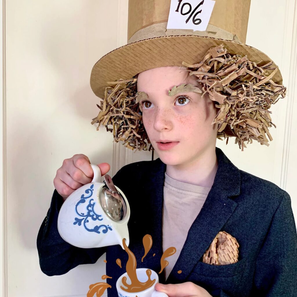 Child in a DIY cardboard Mad Hatter top hat costume