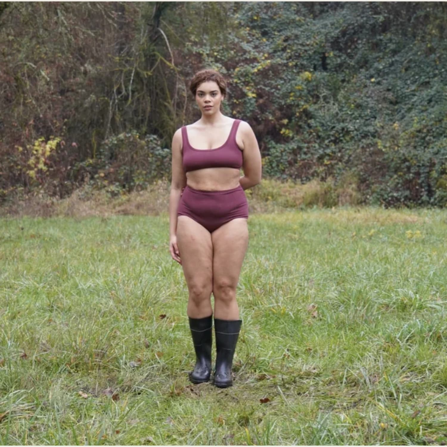 ARQ High-Rise Undies and matching bralette in plum worn outdoors in a grassy field