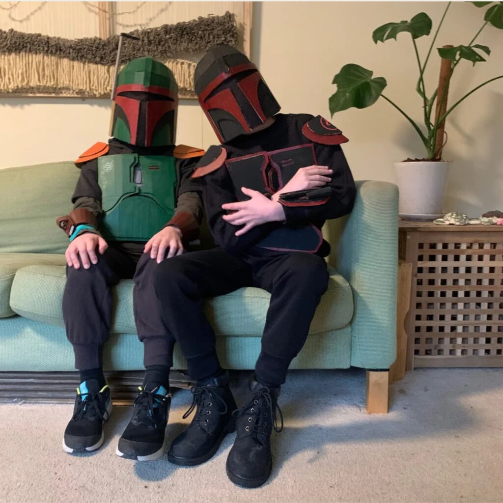 Child in a DIY cardboard bounty hunter helmet and armor costume