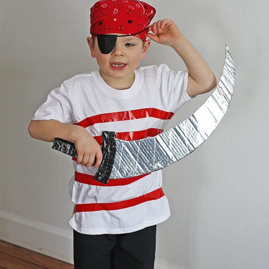 Boy dressed in DIY pirate costume holding a homemade sword.