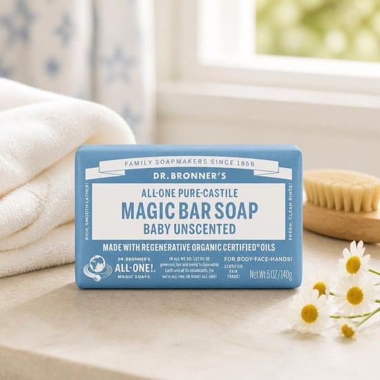 Dr. Bronner's Baby Unscented Pure-Castile Bar Soap on a bathroom counter with a white towel