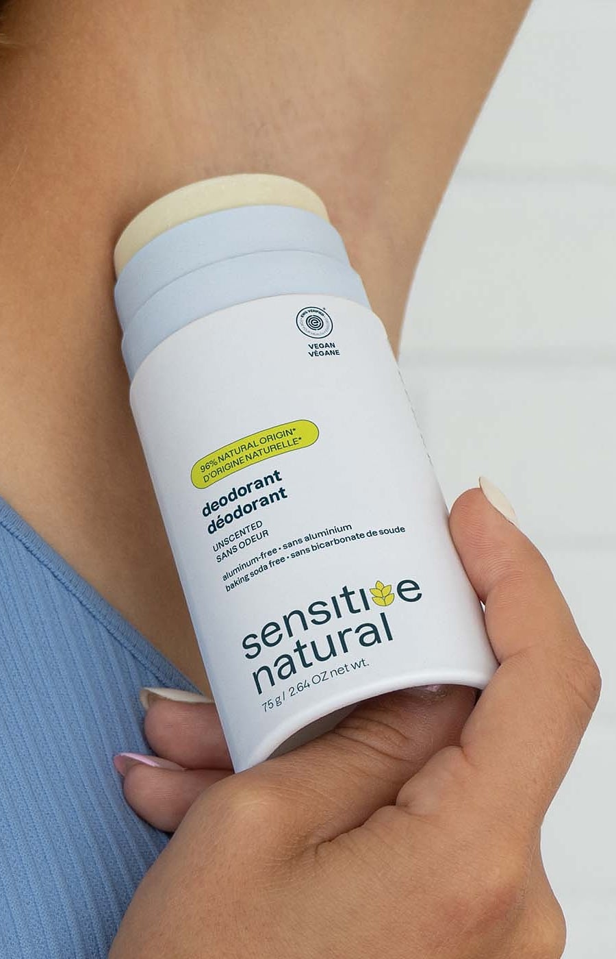 ATTITUDE unscented sensitive skin deodorant in a plastic free cardboard tube being applied
