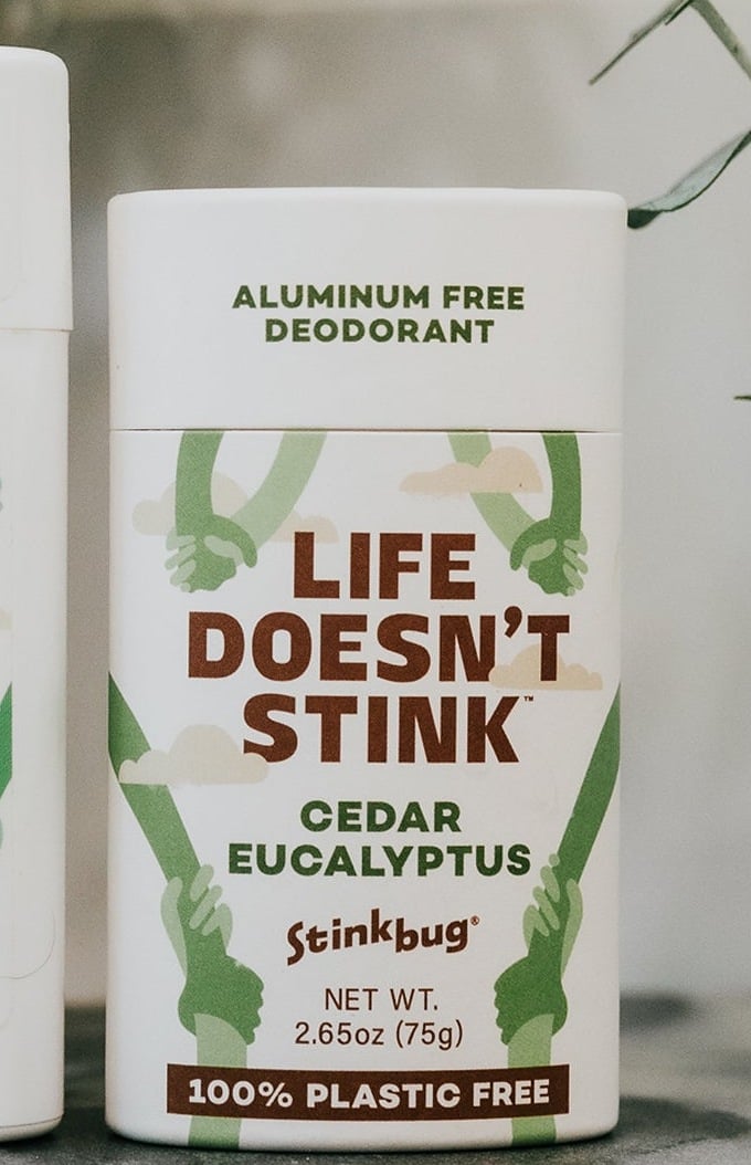 Stinkbug Naturals Cedar Eucalyptus plastic free deodorant in a paper tube on a marble counter